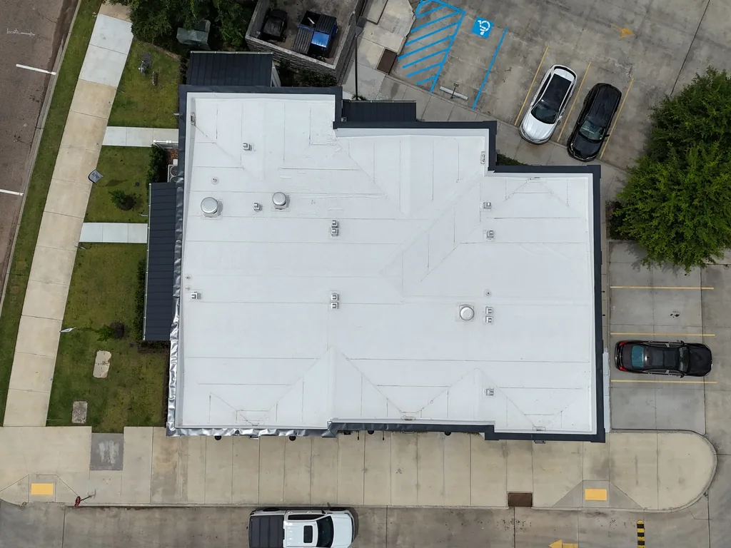 Silicone or acrylic roof coating applied over a commercial flat roof membrane in Baton Rouge, LA